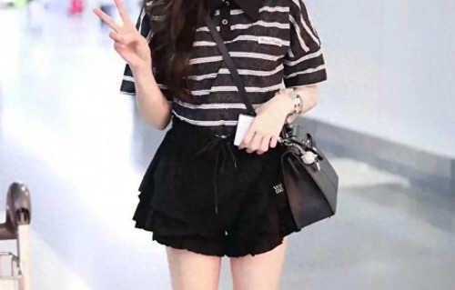 吴宣仪机场秀穿搭，身穿条纹上衣+黑色裙裤，轻松穿出时髦洋气感